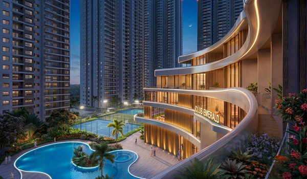 Luxury swimming pool at Prestige Golden Grove featuring a sunken seating area, lounge chairs, and tropical landscaping.