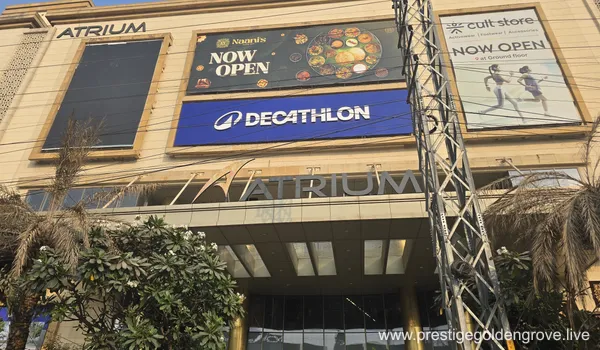 Exterior view of Atrium Mall in Gachibowli, Hyderabad, displaying large signage for Decathlon, Cult Store, and Naani's restaurant against a modern stone facade.