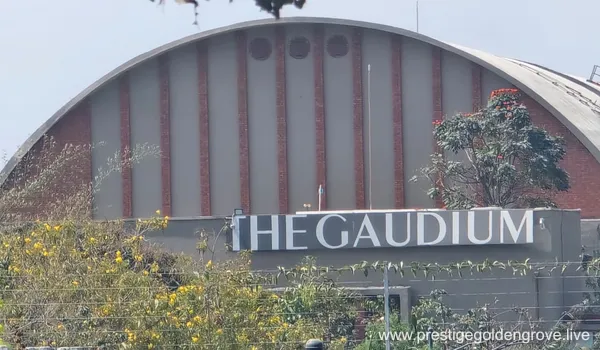 Exterior view of The Gaudium School building located near the Prestige Golden Grove residential project in Kollur, Hyderabad, showcasing nearby educational infrastructure.