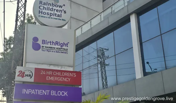 Exterior view of Rainbow Children's Hospital and BirthRight, a multi-story modern healthcare facility. Located approximately 11 km from Prestige Golden Grove (approx. 20-minute drive via the ORR).